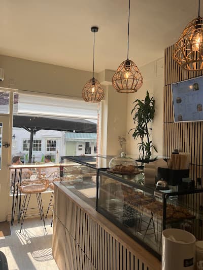 Bright café interior with brick and hanging lights